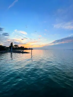 a view of a large body of water at sunset at Luxus Studio Apartment am Bodensee in Güttingen