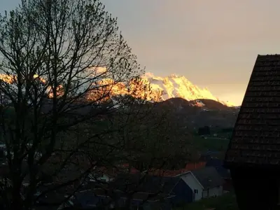 a mountain in the distance with the sun shining on it at Apartment Kleines Loft by Interhome in Gais