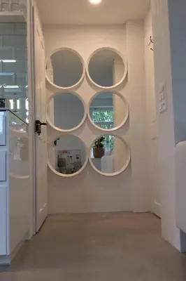 a room with three circular shelves on the wall at Apartment Kleines Loft by Interhome in Gais