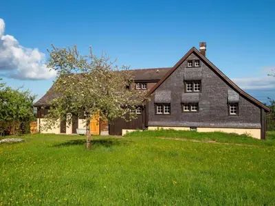 an old barn with a tree in a field at Holiday Home Fromsenrüti by Interhome in Walzenhausen