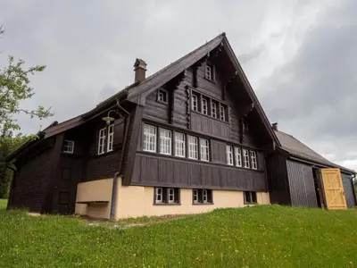 a large wooden building on top of a green hill at Holiday Home Fromsenrüti by Interhome in Walzenhausen