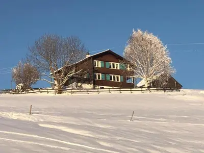 a house on top of a snow covered field at Holiday Home Neuer Sigerst by Interhome in Wildhaus