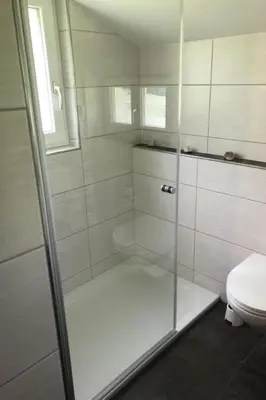 a bathroom with a glass shower with a toilet at Holiday Home Neuer Sigerst by Interhome in Wildhaus