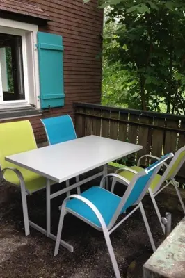 a white table and four chairs on a patio at Holiday Home Neuer Sigerst by Interhome in Wildhaus