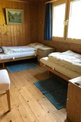 a room with two beds and two rugs at Holiday Home Neuer Sigerst by Interhome in Wildhaus