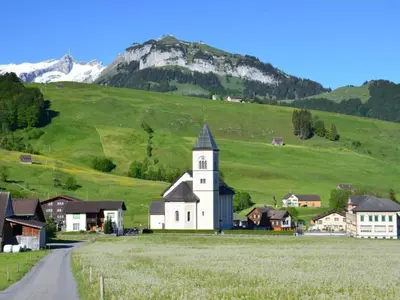 a church in the middle of a green hill at Apartment Sutter in Brülisau bei Appenzell by Interhome in Brülisau