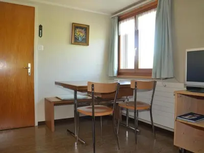 a dining room with a table and chairs and a television at Apartment Sutter in Brülisau bei Appenzell by Interhome in Brülisau
