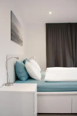 a bed with pillows on it with a window at Apartment Ferien im Toggenburg by Interhome in Krummenau