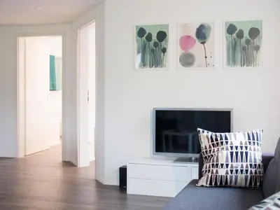 a living room with a couch and a flat screen tv at Apartment Ferien im Toggenburg by Interhome in Krummenau