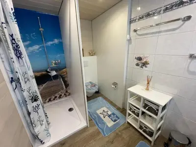 a small bathroom with a shower and a toilet at Apartment Hälmli by Interhome in Heiden