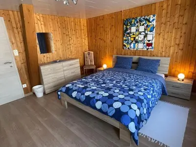 a bedroom with a bed with a blue comforter at Apartment Hälmli by Interhome in Heiden
