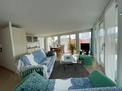 a living room with a couch and a table at Apartment Hälmli by Interhome in Heiden