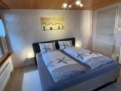 a bedroom with a large bed with two pillows at Apartment Hälmli by Interhome in Heiden