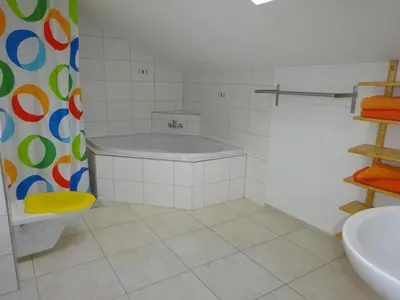 a bathroom with a tub and a toilet and a sink at Apartment Rehalp Westen by Interhome in Bischofszell
