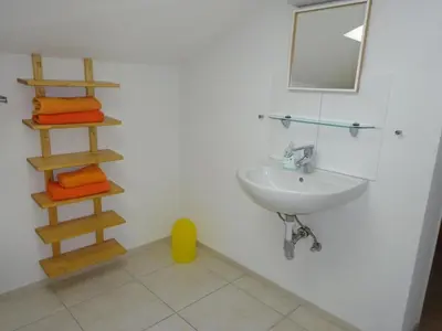a bathroom with a sink and a mirror and towels at Apartment Rehalp Westen by Interhome in Bischofszell