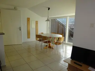 a dining room with a table and chairs and a television at Apartment Rehalp Westen by Interhome in Bischofszell