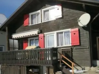 a house with red and white windows and a balcony at Apartment Rheintalblick by Interhome in Oberegg