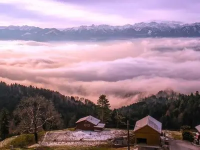 a view of a foggy valley with houses and mountains at Apartment Rheintalblick by Interhome in Oberegg