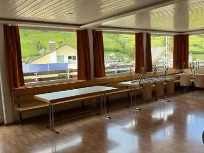 a room with tables and chairs and a large window at Holiday Home Ski- und Gruppenhaus by Interhome in Alt Sankt Johann