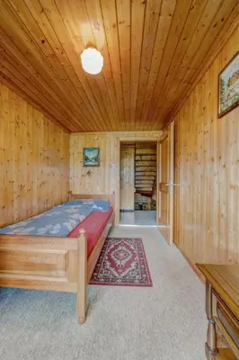 a bedroom with a bed in a wooden room at Apartment Hautle by Interhome in Appenzell Innerrhoden