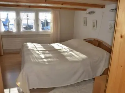 a bedroom with a bed and a window at Apartment Breiten by Interhome in Brunnadern