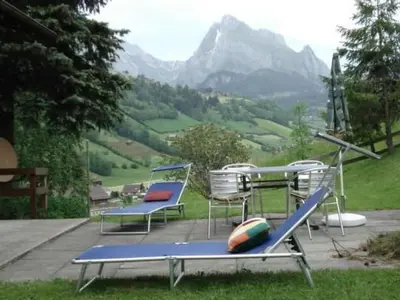 a group of chairs and a slide in front of a mountain at Apartment Bijou by Interhome in Alt Sankt Johann
