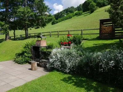 a garden with a fountain and flowers on a hill at Apartment Bijou by Interhome in Alt Sankt Johann