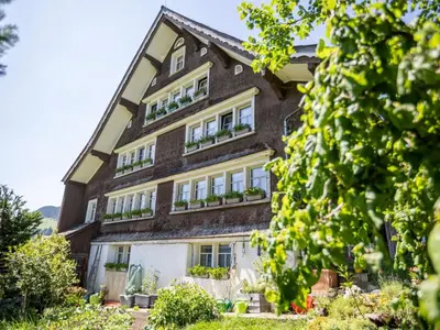 a building with windows and plants on it at Apartment by Interhome in Unterwasser