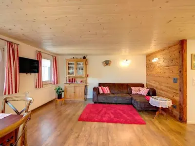 a living room with a couch and a red rug at Apartment Bauernhof Fendrig - neue Wohnung by Interhome in Haslen