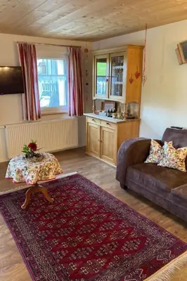 a living room with a couch and a table at Apartment Bauernhof Fendrig - neue Wohnung by Interhome in Haslen