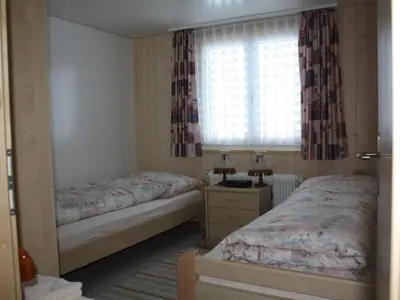 a bedroom with two beds and a window at Apartment Casa Uccello by Interhome in Wildhaus
