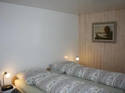 a bedroom with two pillows on top of a bed at Apartment Casa Uccello by Interhome in Wildhaus