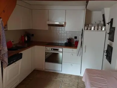 a small kitchen with white cabinets and a refrigerator at Holiday Home Ferien in der Vogelherd by Interhome in Wolfhalden