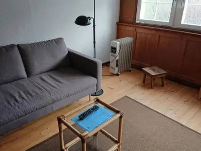 a living room with a couch and a table at Holiday Home Ferien in der Vogelherd by Interhome in Wolfhalden
