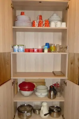 a cupboard filled with bowls and plates and dishes at Apartment Bauernhof ufem Berg by Interhome in Herisau