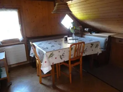 a kitchen with a table and chairs in a room at Apartment Bauernhof ufem Berg by Interhome in Herisau