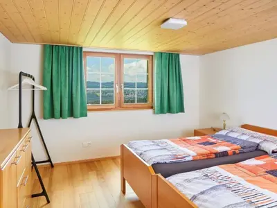 two beds in a room with green curtains at Apartment Hof Höchi by Interhome in Bruggen