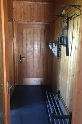 a room with a bed in front of a door at Holiday Home Soldanella by Interhome in Appenzell