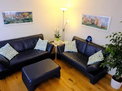 a living room with two leather couches and a table at Apartment Rätia by Interhome in Wolfhalden