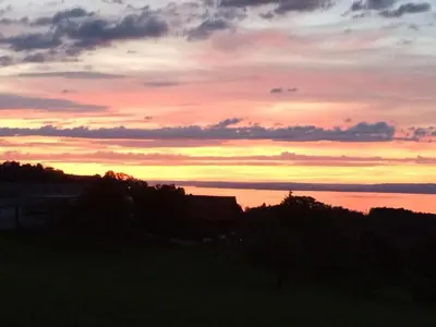 a sunset over a body of water at Apartment Rätia by Interhome in Wolfhalden