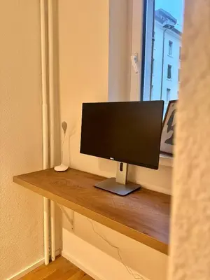 a computer monitor sitting on a table in a room at McNeal Solutions Zentrale Lage direkt am Roten Platz in St. Gallen