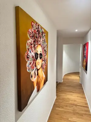a painting of a woman with sunglasses on a wall at McNeal Solutions Zentrale Lage direkt am Roten Platz in St. Gallen