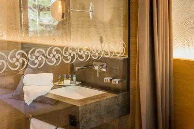 a bathroom with a sink and a mirror at Säntis - das Hotel in Schwagalp