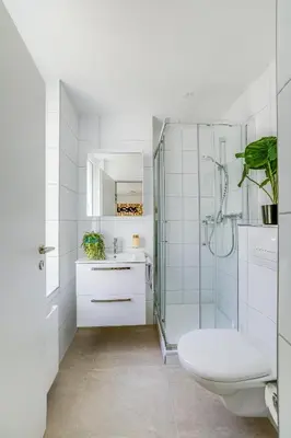 a white bathroom with a toilet and a shower at Urban Hideaway Studio St Gallen Center in St. Gallen