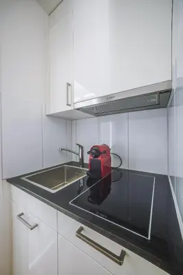 a red appliance sitting on a counter in a kitchen at Urban Hideaway Studio St Gallen Center in St. Gallen