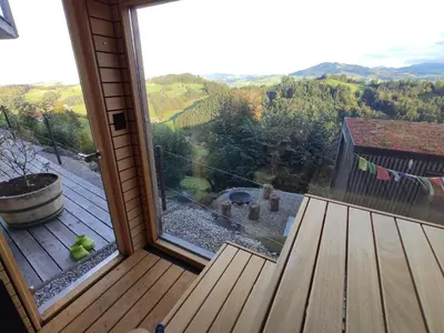 a sliding glass door to a deck with a view at Ihre Wohlfühloase in Schwellbrunn