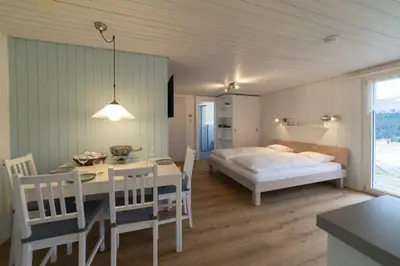 a bedroom with a bed and a table and chairs at Studio Muerner in Wildhaus