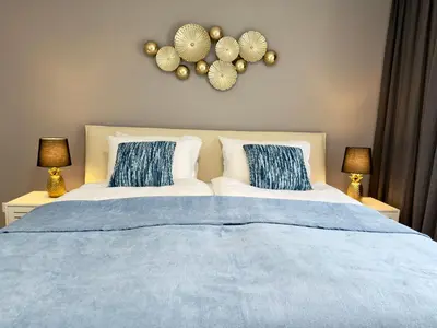 a bedroom with a bed with blue and white pillows at Sunset I Bodensee I St Gallen I Bregenz I Appenzell I Vaduz in Rorschacherberg