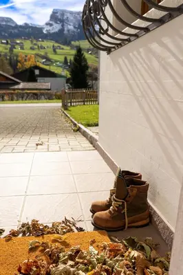 a pair of boots sitting next to a wall at Sonnegge in Wildhaus
