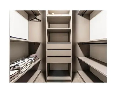 a walk in closet with white cabinets and shelves at Zuhause am Bodensee in Bottighofen